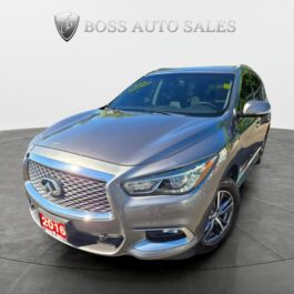 A silver 2016 Infiniti QX60 AWD is on display at Boss Auto Sales, positioned to show its front and driver’s side with the dealership's shield logo visible in the background.