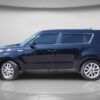 A black 2018 Kia Soul EX with four doors is displayed from the side in a well-lit studio with a neutral background. The car has tinted windows and appears clean and well-maintained.