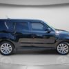 A 2018 Kia Soul EX compact hatchback in black is parked indoors on a curved white backdrop, shown in a side view.