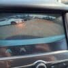 The 2017 Chevrolet Cruze 2LT Turbos rearview camera displays a live parking lot feed with parked cars. Red guidelines assist in parking alignment, all framed by the dashboard.