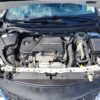 The image displays the engine compartment of a 2017 Chevrolet Cruze 2LT Turbo with the hood open, highlighting the prominent ECOTEC cover and various components, hoses, and wires. The metal frame and front section offer a detailed look into the vehicles turbo powerhouse.