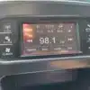 The 2015 Dodge Journey SEs dashboard features FM station 98.1 with AM/FM, tune, audio, and info options. Surrounding buttons include radio, player, climate, settings, more, and screen off. The clock displays 12:15.