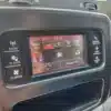 A close-up of the 2015 Dodge Journey SEs climate control dashboard shows max A/C, seat heating options, and a 12:15 clock. It features buttons for radio, player, climate settings, more options, and screen off controls for convenience.