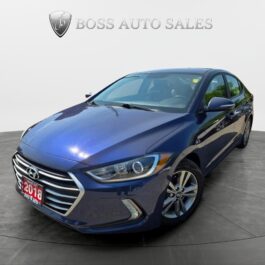 A 2018 Hyundai Elantra Limited sedan in blue is showcased in a showroom beneath the Boss Auto Sales logo, positioned to emphasize its alloy wheels and modern headlights, highlighting its stylish design. A 2018 Hyundai Elantra Limited sedan in blue is showcased in a showroom beneath the Boss Auto Sales logo, positioned to emphasize its alloy wheels and modern headlights, highlighting its stylish design.