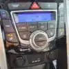Close-up of a 2014 Hyundai Elantra GTs climate control panel featuring A/C, temperature, mode, and fan speed buttons. The digital screen reads Lo. USB and auxiliary ports are below with two 12V power outlets.