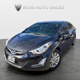 A black 2016 Hyundai Elantra Sport sedan is angled to show its front and driver’s side, parked in a showroom with BOSS AUTO SALES displayed on the wall behind it.