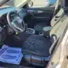 The 2014 Nissan Rogue 2.5 SV features black fabric seats and a pristine dashboard, with the steering wheel, gear shift, and center console distinguished in the clean interior. A paper mat on the drivers side graciously says, Your business is appreciated.
