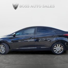 A black 2016 Hyundai Elantra Sport four-door sedan is displayed in side profile on a gray showroom floor, with BOSS AUTO SALES and its shield logo above the car.