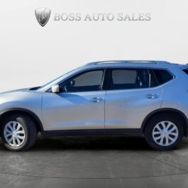 A 2014 Nissan Rogue 2.5 SV is parked on a gray surface in a showroom with the Boss Auto Sales logo above, shown from the side with all four wheels and tinted windows visible.