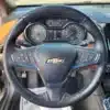 A 2017 Chevrolet Cruze Premier Hatchback interior close-up features a Chevrolet steering wheel with control buttons, a visible instrument cluster, and part of the infotainment display to the right.