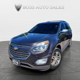 A 2016 Chevrolet Equinox LTZ AWD in dark blue is showcased in a showroom, angled to display its front and driver’s side beneath the Boss Auto Sales sign.