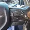 Close-up of a 2015 Chrysler 200 S AWD steering wheel with cruise control buttons labeled SET+, SET-, RES, and CANC, highlighting driving precision and comfort. Dashboard and speedometer appear blurred in the background.