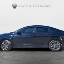 A 2015 Chrysler 200 S AWD in dark blue is parked indoors before a plain backdrop with the Boss Auto Sales logo above it, seen from the side to highlight its tinted windows and alloy wheels.