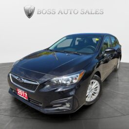 A black 2017 Subaru Impreza Premium HB is shown on a circular platform in a showroom, with the Boss Auto Sales logo behind it and a red license plate visible.