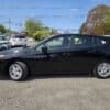 A 2017 Subaru Impreza Premium HB in black is parked in a lot on a sunny day, with other cars and trees in the background. The side view highlights its clean exterior and alloy wheels.