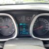 Dashboard of a 2017 Chevrolet Equinox 2LT AWD shows tachometer, digital display at 0 km/h, odometer at 129399 km, speedometer up to 220 km/h, warning lights on, and sunlight illuminating the instrument cluster.
