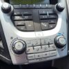 Close-up of the 2017 Chevrolet Equinox 2LT AWD’s climate control and audio panel, showing buttons and knobs for fan speed, temperature, A/C, heated seats, and media controls in this all-wheel-drive SUV.
