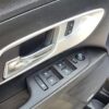 Close-up of a 2017 Chevrolet Equinox 2LT AWD interior door panel, featuring a chrome handle, lock/unlock buttons, four window controls, and a circular side mirror adjustment—distinctive elements of this SUV.