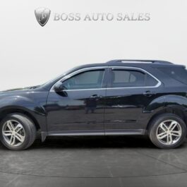 A 2017 Chevrolet Equinox 2LT AWD black SUV with alloy wheels is parked indoors on a gray tiled floor, viewed from the driver’s side. The Boss Auto Sales logo and name are visible on the white wall in the background.