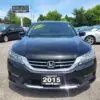 A black 2015 Honda Accord Touring V6 is parked at BOSS AUTO dealership. The windshield features a yellow Loaded sticker, with other cars visible in the background.