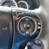 A close-up of the 2015 Honda Accord Touring V6 steering wheel features cruise control buttons labeled Cruise, Res +, Cancel, and Set. It has a textured leather finish, with part of the refined dashboard subtly visible in the background.