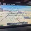 The GPS in a 2015 Honda Accord Touring V6 shows Oshawa on the map with the car marked as Not on a digitized road. The radio is set to 99.9 MHz FM at 11:58, and the distance reads 1.6 km.
