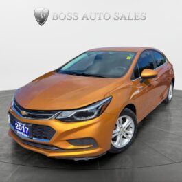 A 2017 Chevrolet Cruze LT Turbo sedan in orange is displayed on a gray circular platform in a showroom, with the Boss Auto Sales logo visible in the background. A 2017 Chevrolet Cruze LT Turbo sedan in orange is displayed on a gray circular platform in a showroom, with the Boss Auto Sales logo visible in the background.