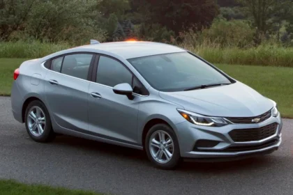 A silver sedan, among the best models to consider if you plan to buy used, is parked on a paved road beside a grassy area. With its headlights and top-mounted light on, the scene unfolds in daylight with trees providing the perfect backdrop. A silver sedan, among the best models to consider if you plan to buy used, is parked on a paved road beside a grassy area. With its headlights and top-mounted light on, the scene unfolds in daylight with trees providing the perfect backdrop.