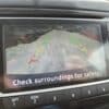 The rearview camera display of the 2018 Nissan Sentra SV shows a snowy driveway with red, yellow, and green guide lines to indicate distance, along with the message Check surroundings for safety and visible control buttons around the screen.