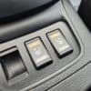 Close-up of a 2018 Nissan Sentra SV seating control showcasing two black toggle switches labeled HI and LO, featuring seat icons with heat waves, set in refined black textured plastic typical of the models interior.