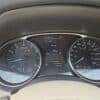 Close-up of the 2015 Nissan Rogue 2.5 SL AWD dashboard with speedometer, tachometer, AWD indicator, fuel and temp gauges, digital display showing 112,495 km mileage, 195 km range, 19°C temperature, and park mode.
