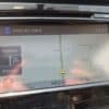 A 2015 Nissan Rogue 2.5 SL AWD GPS display shows the car on Simcoe St North at 11:33 AM near Seneca Ave and Sarcee St, with the FM radio tuned to CJXX and speed limit plus route options visible on screen.