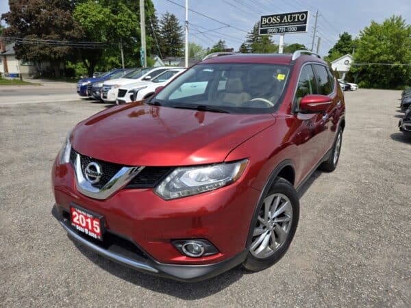 A 2015 Nissan Rogue 2.5 SL AWD is parked in a dealership lot with other vehicles and a Boss Auto sign visible in the background.