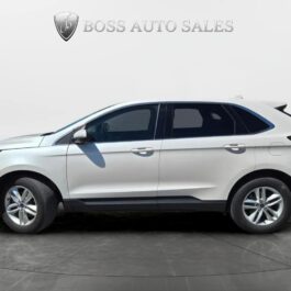 A 2017 Ford Edge SEL is displayed in profile against a light background with the Boss Auto Sales logo above. The SUV features tinted windows and alloy wheels, presented in a showroom setting.