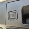 Close-up of a trunk release button on the interior panel of a 2020 Cadillac XT4 Sport AWD, featuring an open trunk icon.