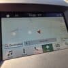 The 2017 Ford Edge SEL’s GPS screen shows a map with a red arrow, current time (11:20), temperature (17°C), and location near Cayuga Ave, Oshawa, ON. Navigation and menu options are visible at the bottom.