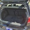 Open the trunk of the 2015 Volkswagen Golf 1.8T Highline hatchback to reveal a clean, spacious cargo area with two floor mats and a LOW KMS sign visible behind the rear seats.