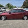 A 2012 Honda Civic LX in maroon is parked in a lot on a sunny day, with houses and other cars visible in the background.