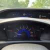 The 2012 Honda Civic LX dashboard displays a speedometer at 0 mph, tachometer near 1000 RPM, warning lights illuminated, gear in P, and a DOOR OPEN indicator, with green trees visible through the windshield.