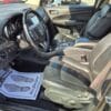 The 2017 Dodge Journey Crossroad V6 AWD has black leather seats, a control-equipped steering wheel, a center console, and a driver’s floor mat reading “Please Drive Safely,” with sunlight streaming into the interior.