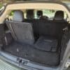 Open the trunk of a 2017 Dodge Journey Crossroad V6 AWD with black interior, showing one rear seat up and one down, plus two floor mats in the spacious cargo area.
