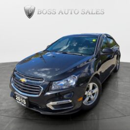 The 2015 Chevrolet Cruze 2LT in black sits on a circular platform in the showroom, headlights on, body gleaming with reflections, and the Boss Auto Sales logo visible in the background. The 2015 Chevrolet Cruze 2LT in black sits on a circular platform in the showroom, headlights on, body gleaming with reflections, and the Boss Auto Sales logo visible in the background.