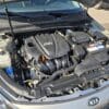 The image shows the 2013 Kia Optima EX engine bay with the hood open, displaying key components such as the GDi engine cover, battery, and fluid reservoirs.