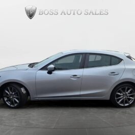 A silver hatchback car is shown in a side view on a gray studio floor, with Boss Auto Sales logo and text displayed above it on a plain white background.