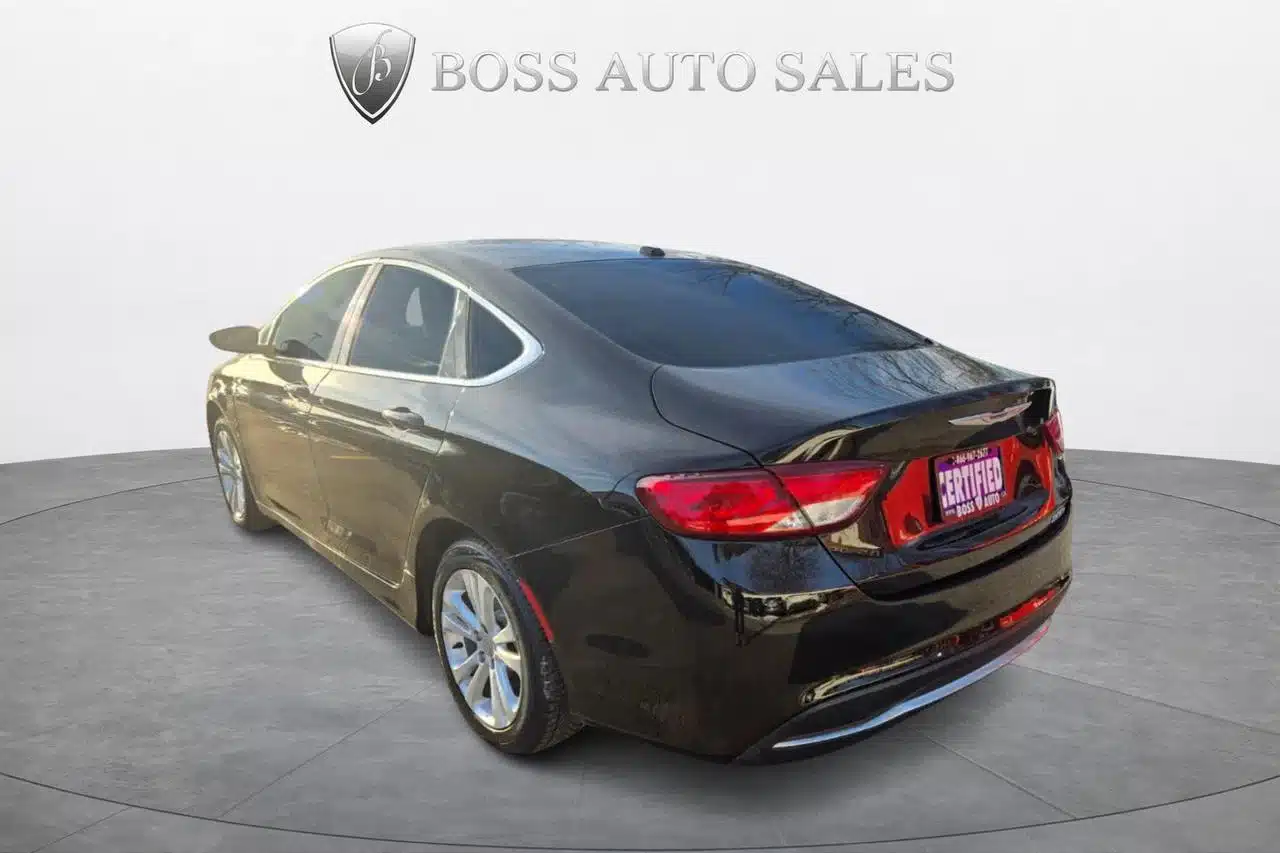 A 2015 Chrysler 200 Limited in black is showcased on a circular platform, with a Boss Auto Sales logo above. The car is angled to display its left side and rear, and the license plate area features “BOSS AUTO SALES.”.