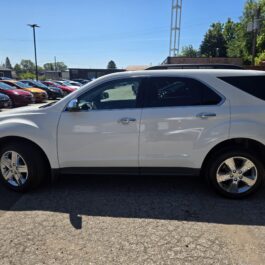 A 2015 Chevrolet Equinox 2LT AWD in white is parked in a car lot on a sunny day, surrounded by other vehicles and trees in the background. A 2015 Chevrolet Equinox 2LT AWD in white is parked in a car lot on a sunny day, surrounded by other vehicles and trees in the background.